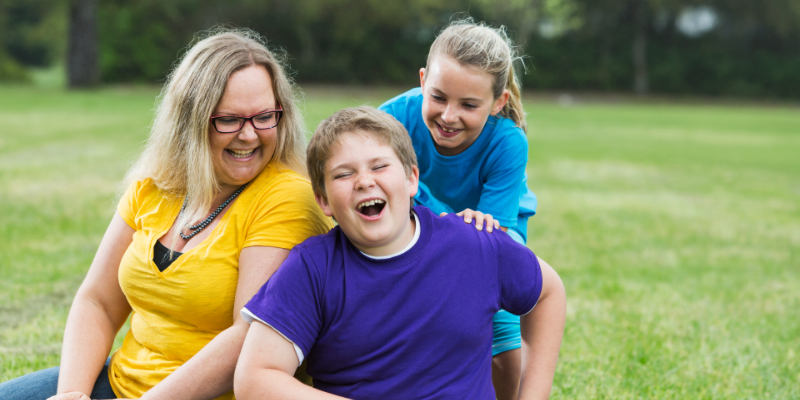 Three people laughing happily together. 