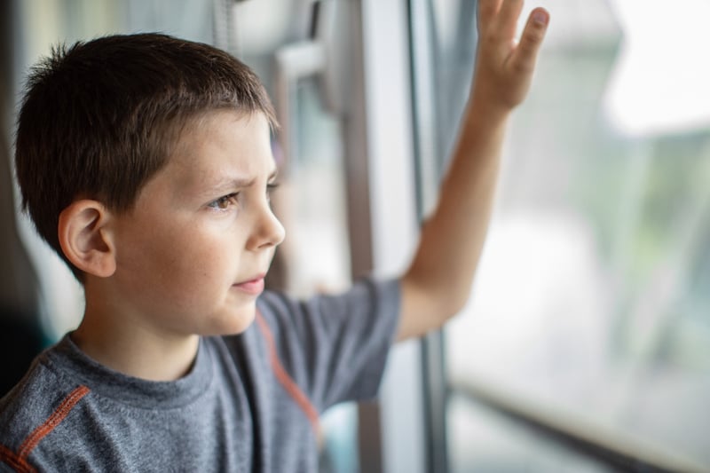 A boy looking outside the window. 