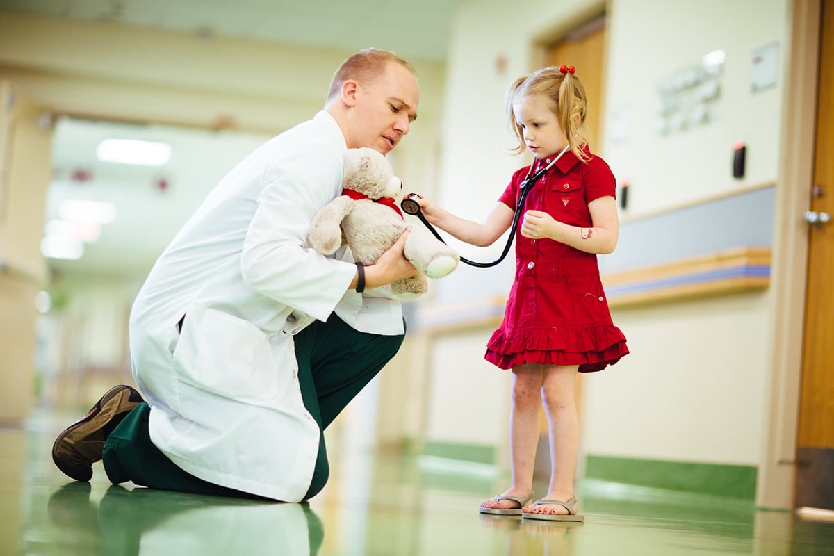 doctor with female patient and bear