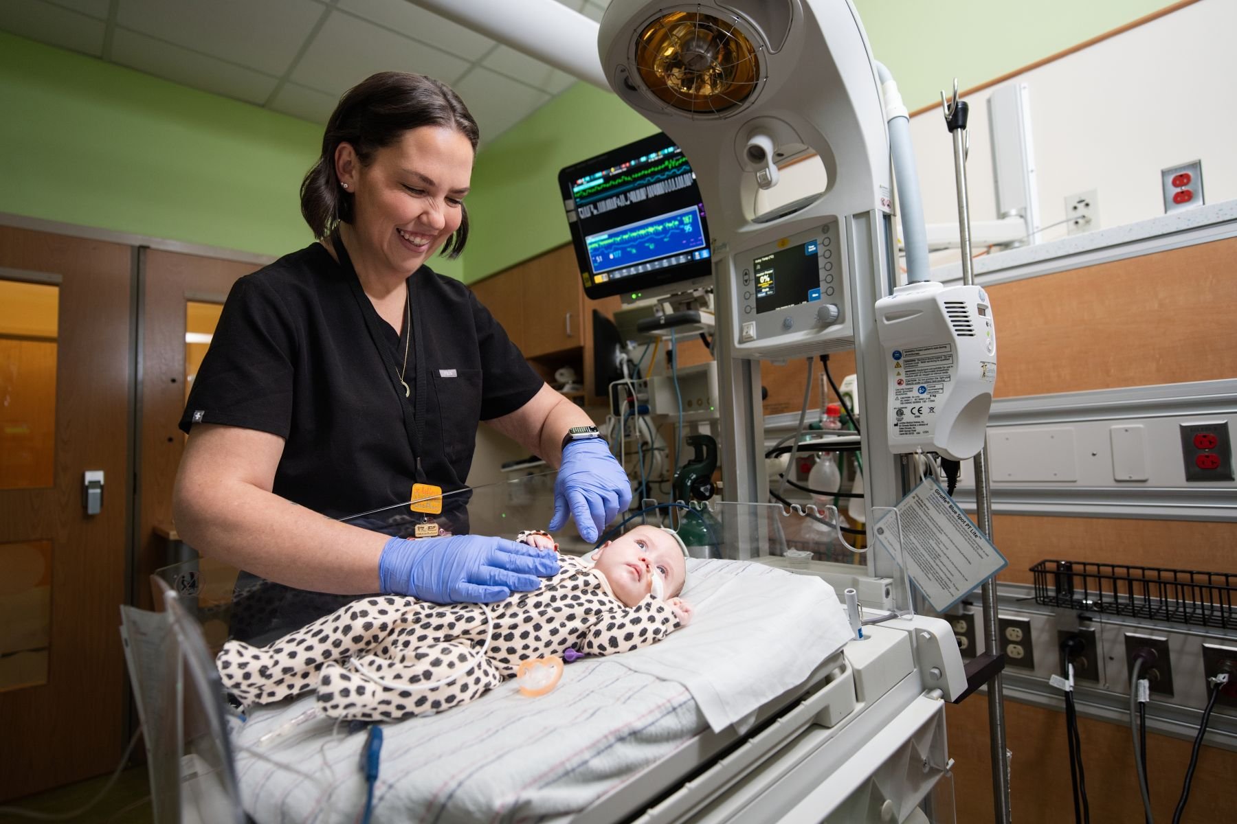 Nurse with a baby in an incubator