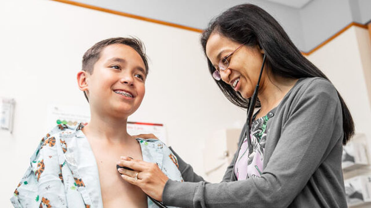 Provider checking a patients heart with a stethescope