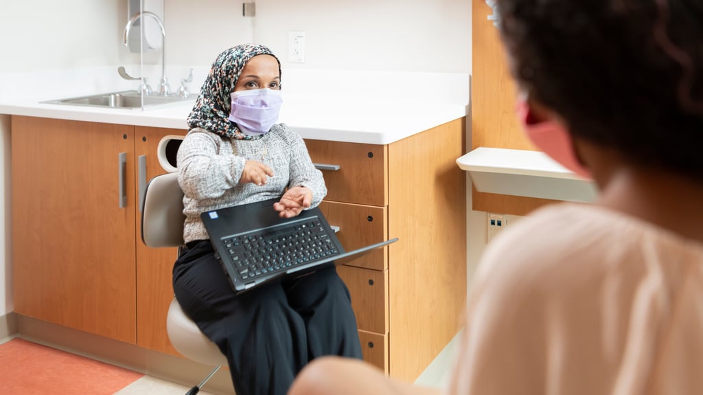 Doctor wearing mask speaking with patient family