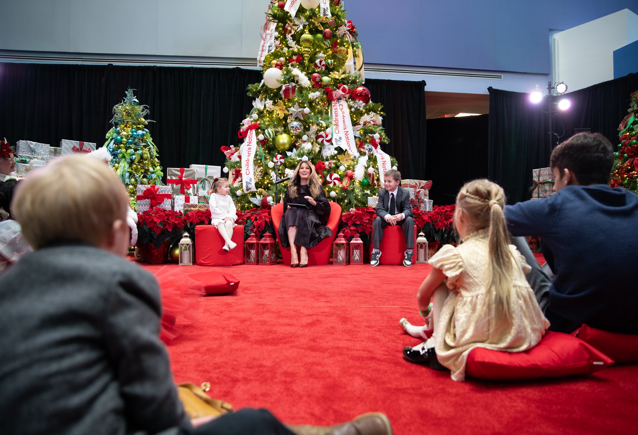 Children listening to the First Lady read a christmas story