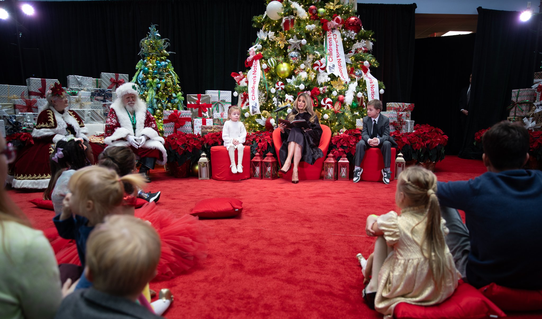 More children listening to the First Lady read a Christmas story