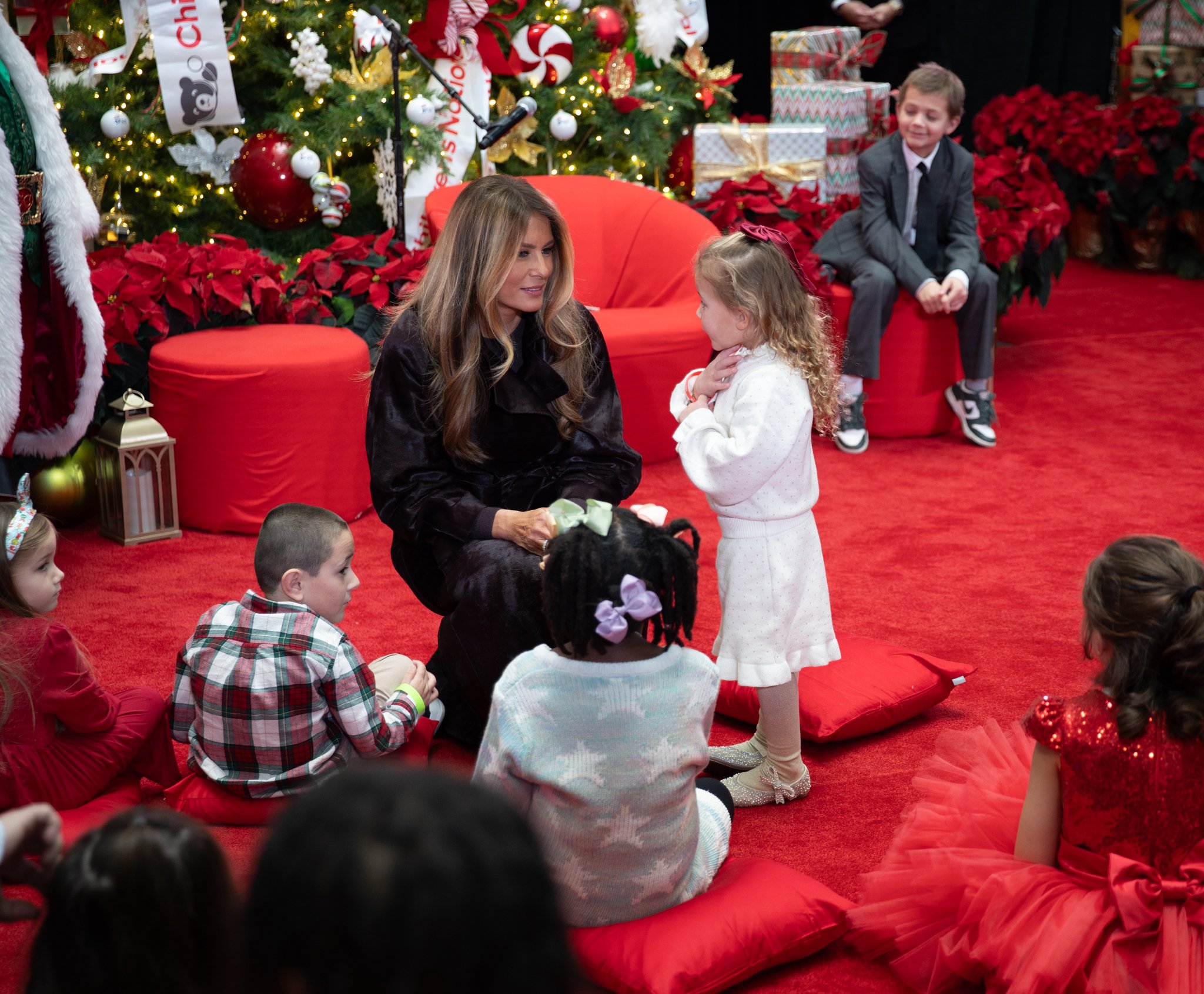 The First Lady visiting with children.