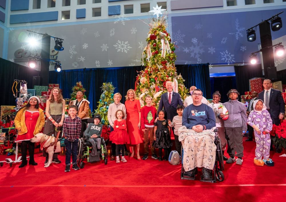 President Joe Biden and First Lady Jill Biden gather with patients in front of the holiday tree at Children's National Hospital