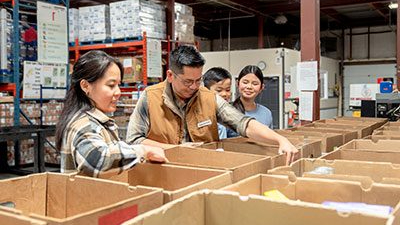 family helping at food bank