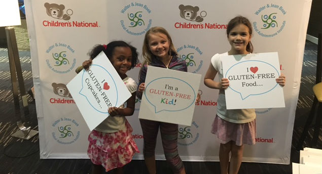 three little girls holding signs