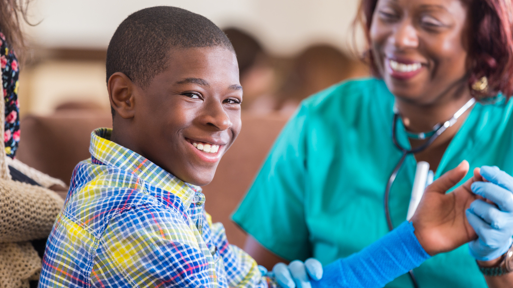 Smiling boy with cast on arm