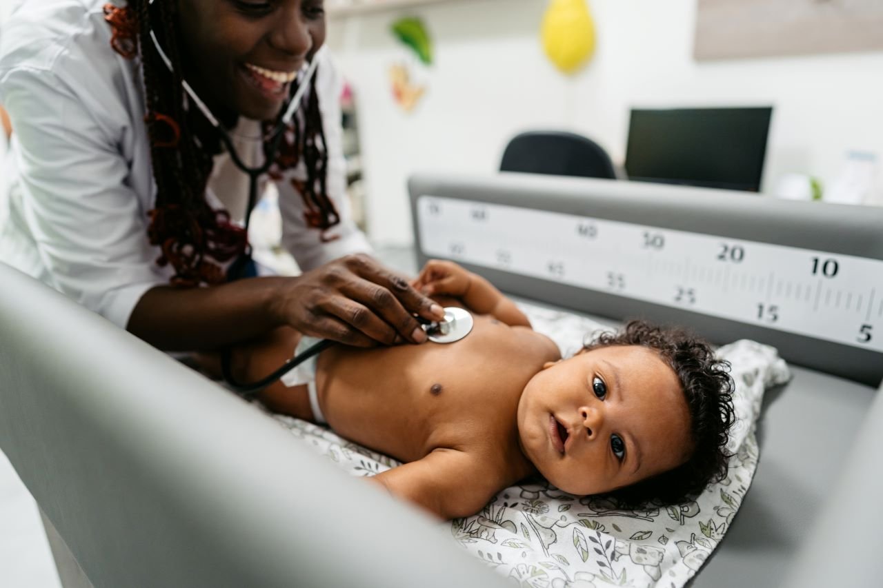 female doctor examining baby