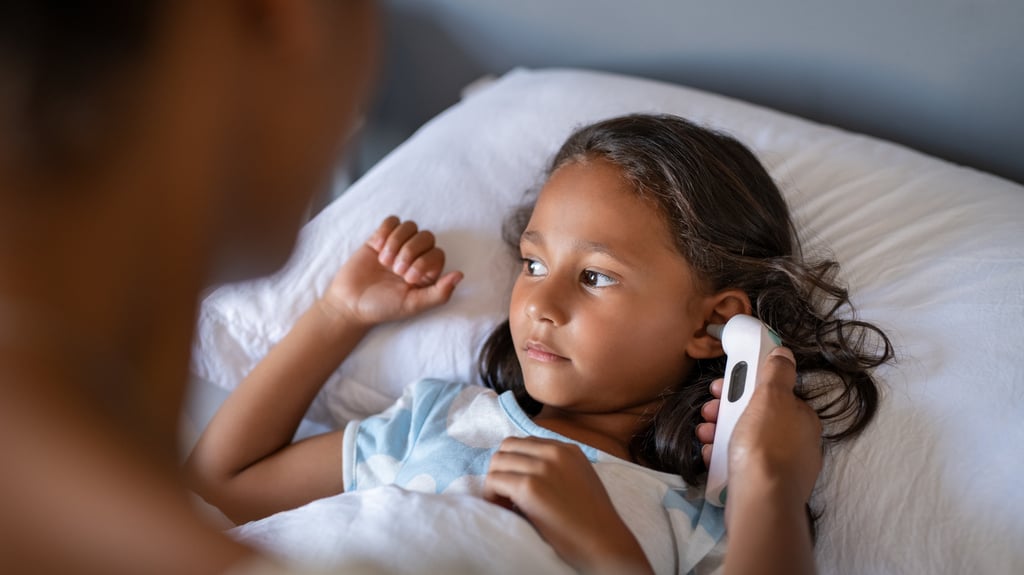 mom checks sick child's temperature