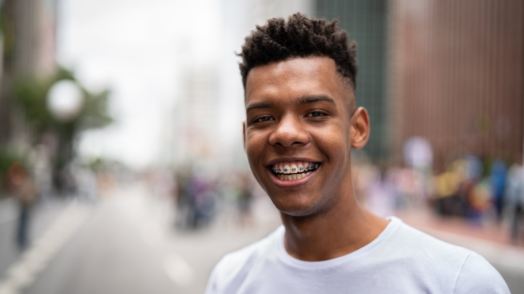 Teenaged boy with braces smiling