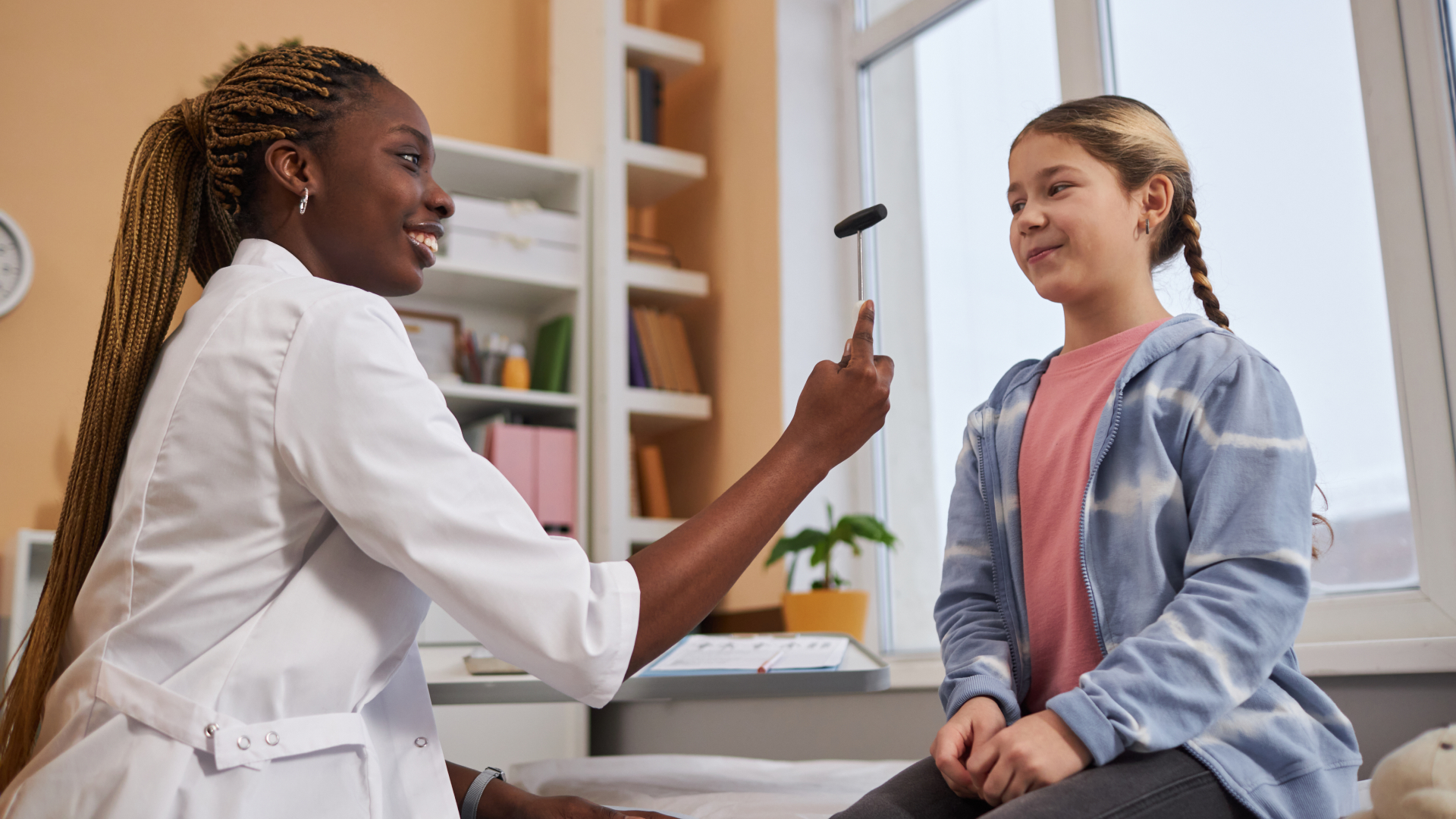 doctor gives child neurology examination