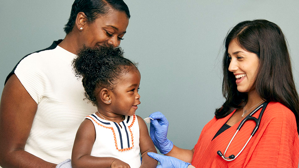 doctor gives young child vaccine