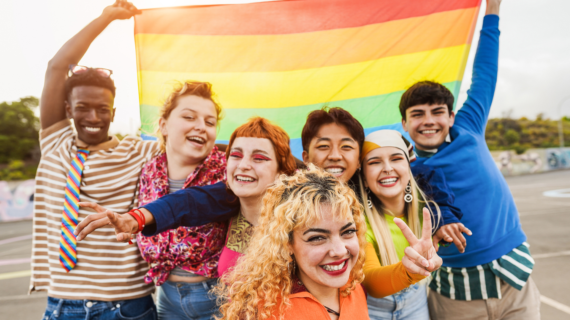 friends holding rainbow flag