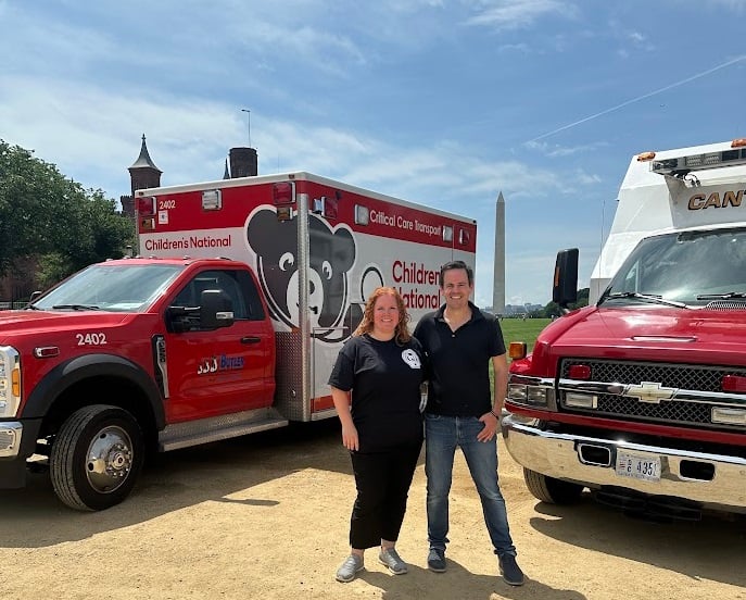 DC EMSC program staff next to Children's National ambulances in front of the Washington Monument on the National Mall
