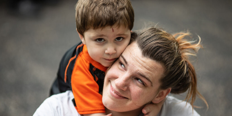 mom and son play in healing garden