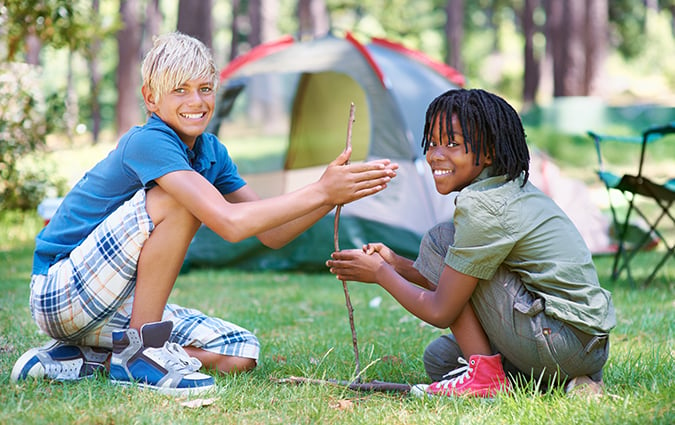 Two school age boys camping