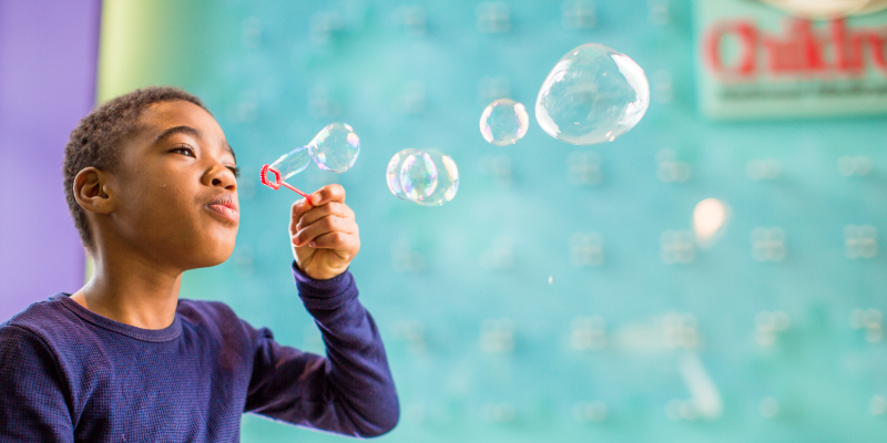 boy blowing bubbles