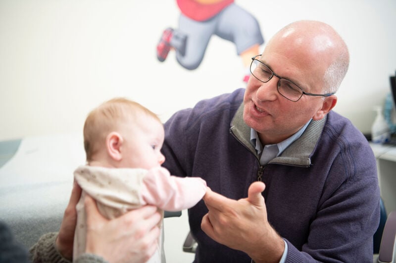 Chief of the Division of Colorectal & Pelvic Reconstruction Dr. Marc Levitt interacts with patient (baby).