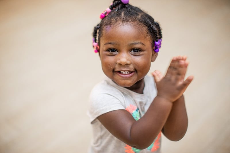 Girl Smiling and Clapping