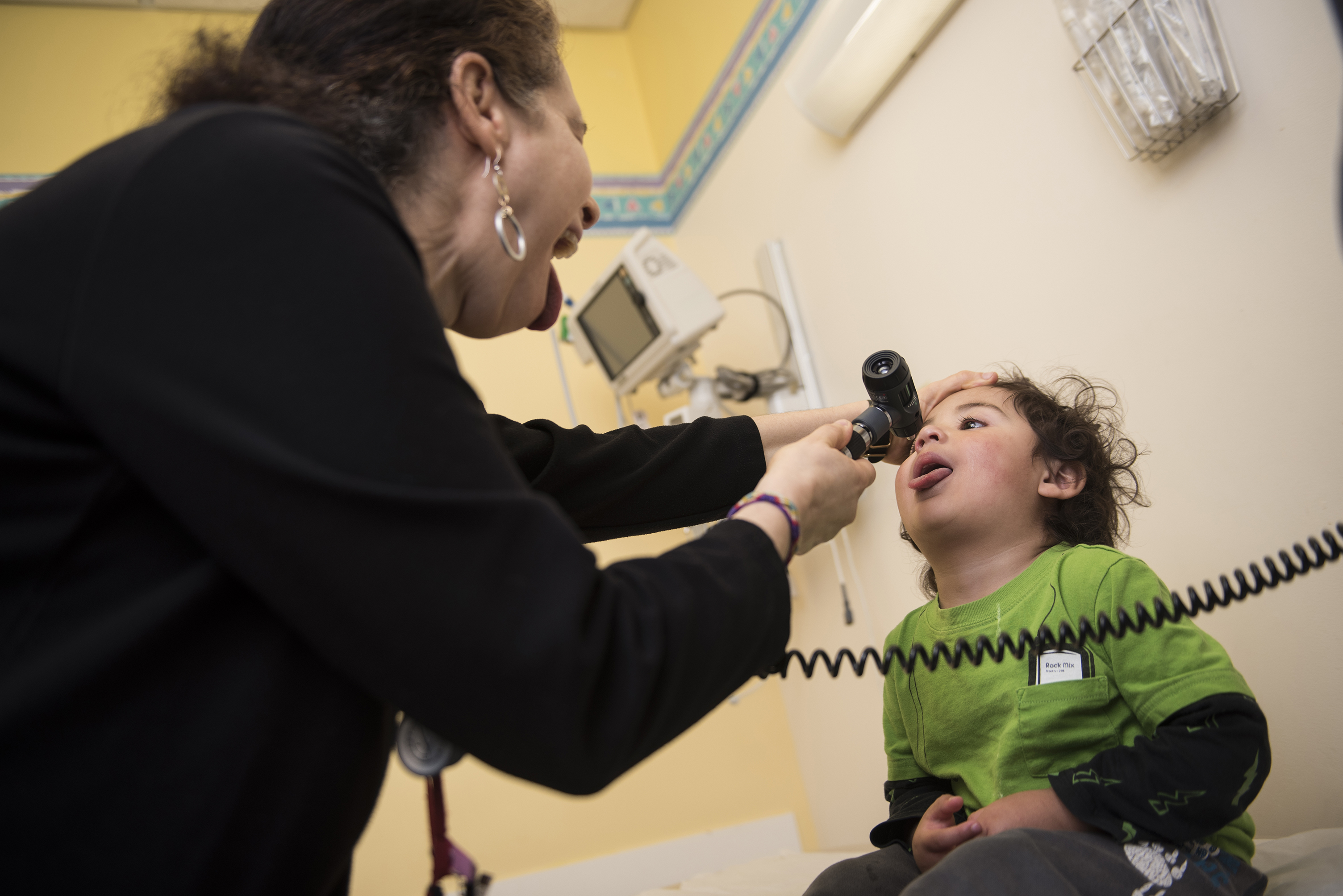 A Children's National Health System provider checks the throat of a patient with a laryngoscope.