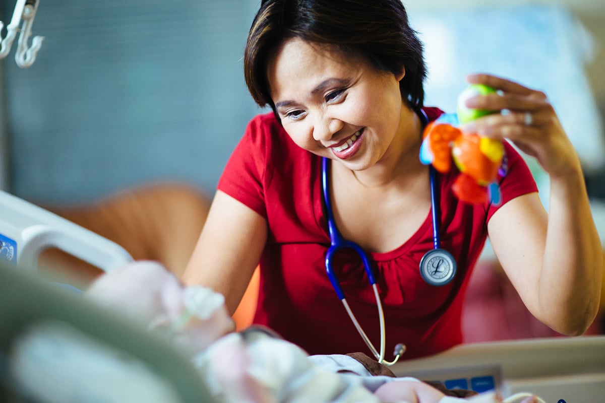 nurse holding toy with baby