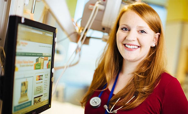 nurse with red hair at computer