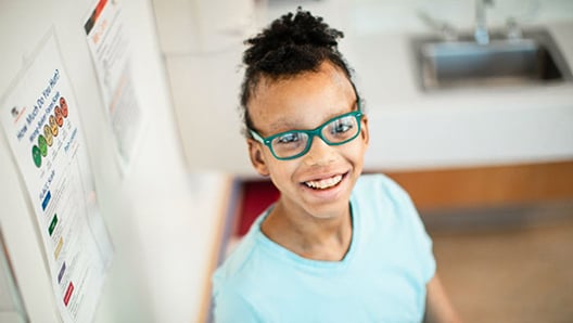 Young girl with glasses smiling