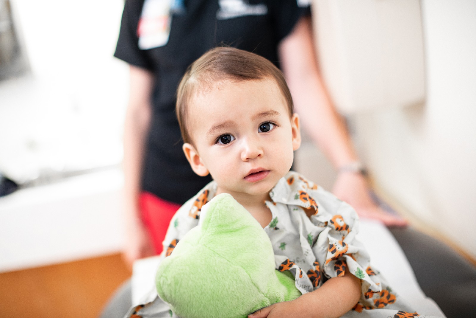 Young Girl Patient With Stuffed Animal In Exam Room