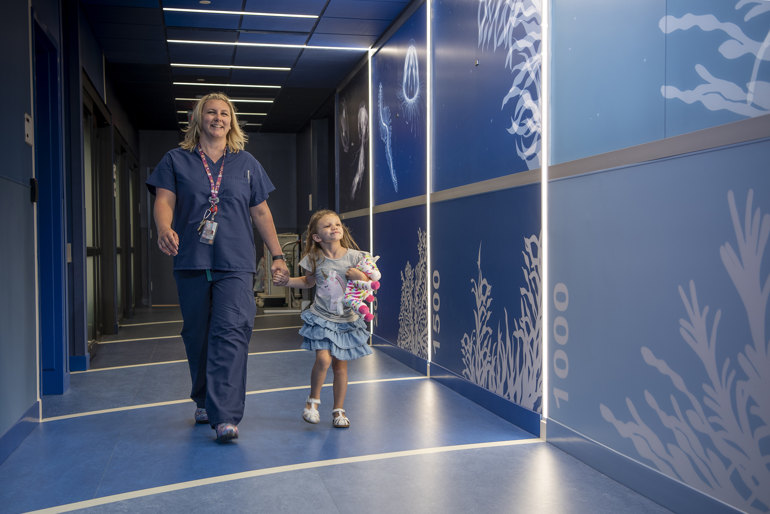 Young Girl Patient with Radiology Nurse in Hallway