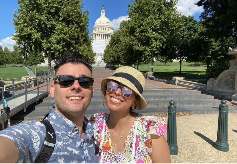 Two fellows pose in front of the Capitol.