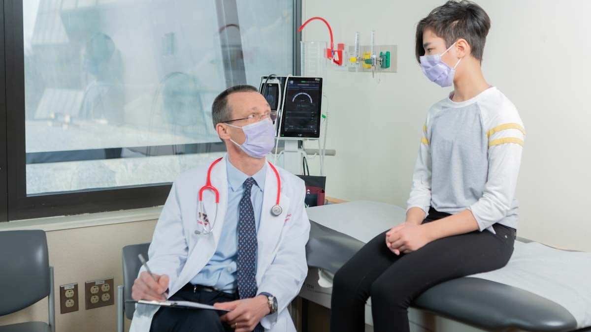 provider with teenager in exam room