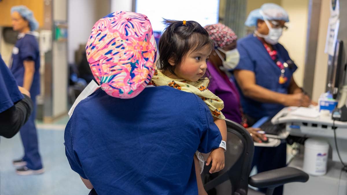 provider carrying young girl