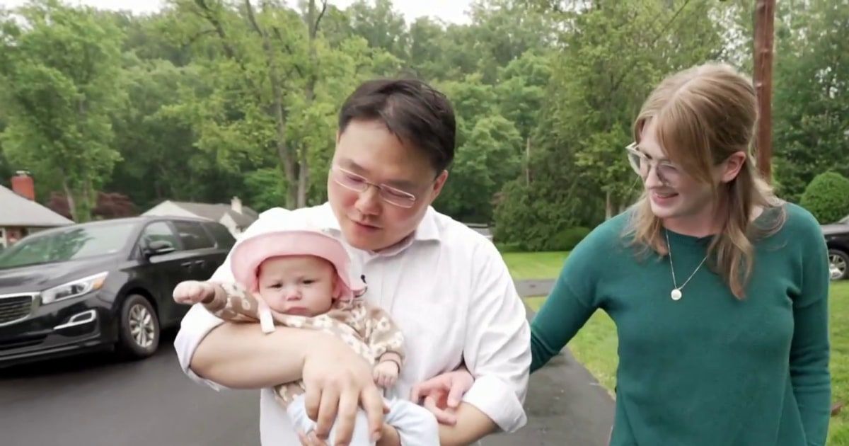 Abby is held by her parents after receiving a pacemaker the size of a pill.