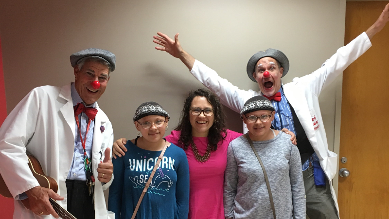 Dr. Kirkorian with patients and clowns