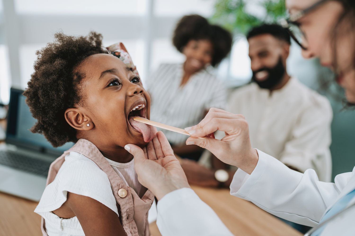 Provider examining a young girl's throat