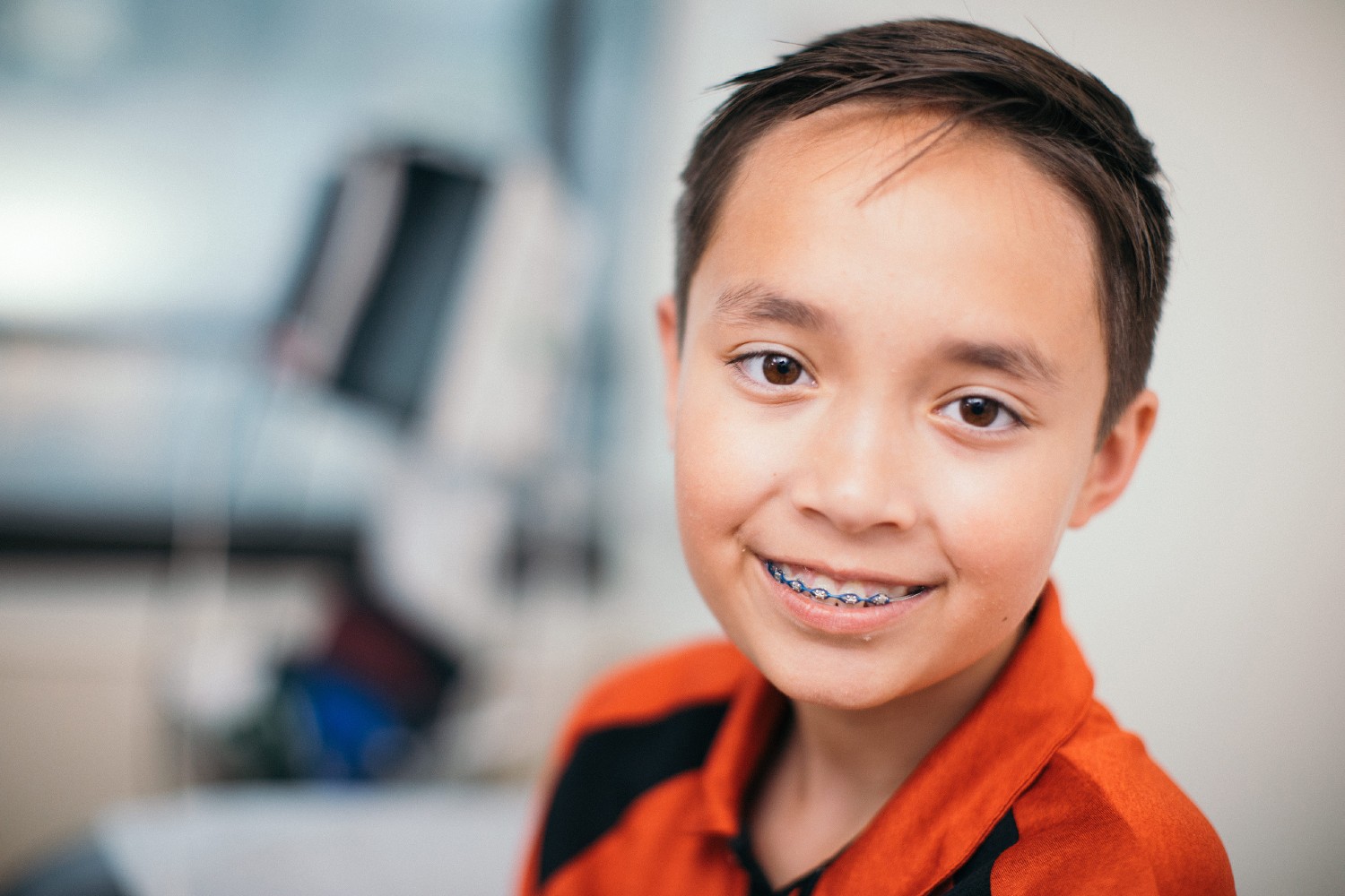 Boy With Braces Smiling in Exam Room