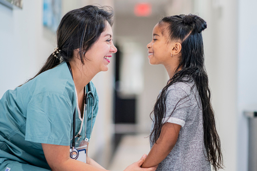 girl and doctor smiling