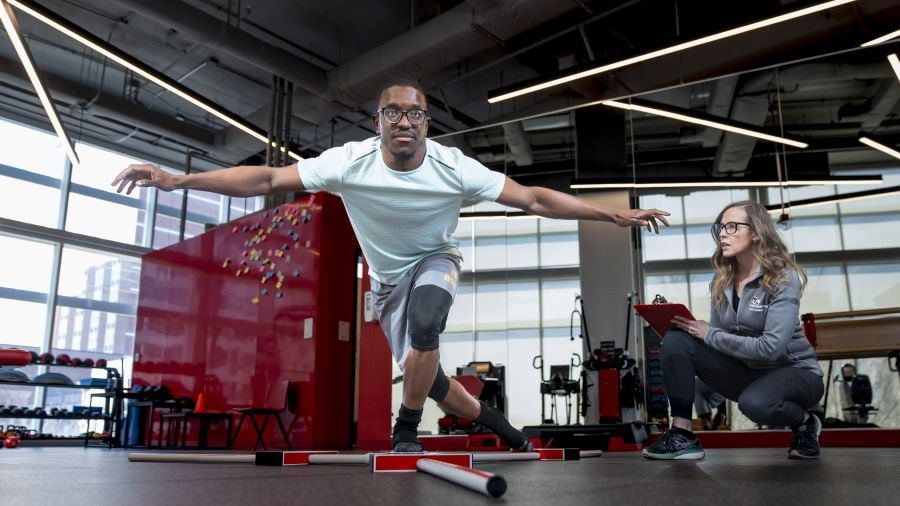 Young man tests balance as part of Sports Performance and Injury Prevention program.