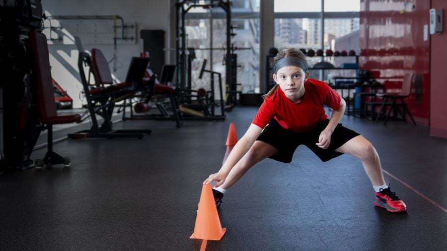 Teenage girl exercise in between cones as part of Sports Performance and Injury Prevention program.