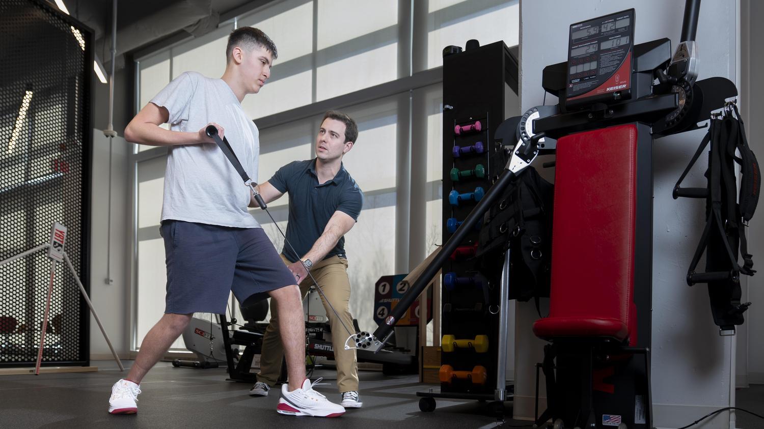 Physical therapist working with patient on a strength exercise
