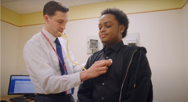 Photo of doctor using a stethoscope on male patient