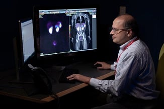 Doctor looking at patient scans on a computer