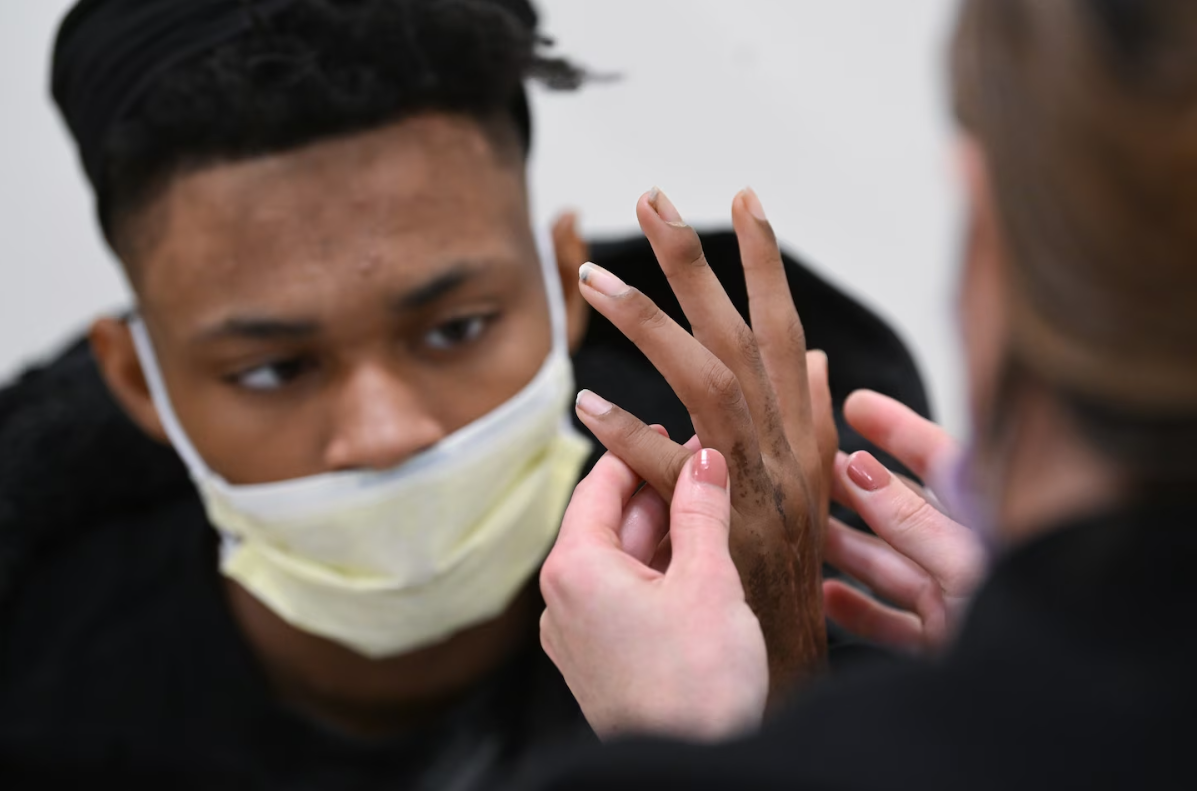 Provider examines injured hand
