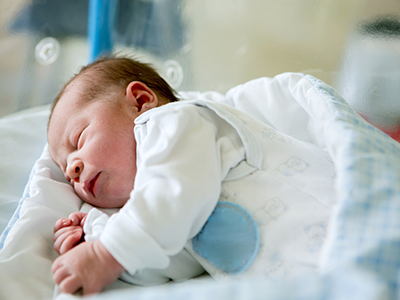 Newborn baby lying in crib