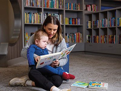 Child Life Specialist Lanie Berk reads to Jack in our Family Resource Center