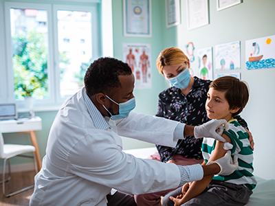 little boy getting flu shot