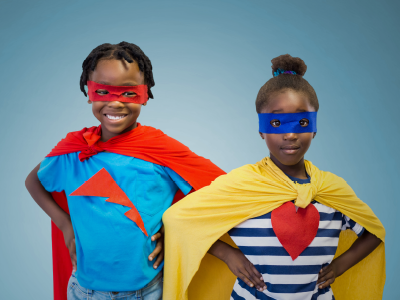 A boy and girl dressed as superheroes