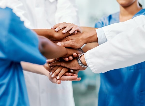 A group of providers stacking their hands on top of each other